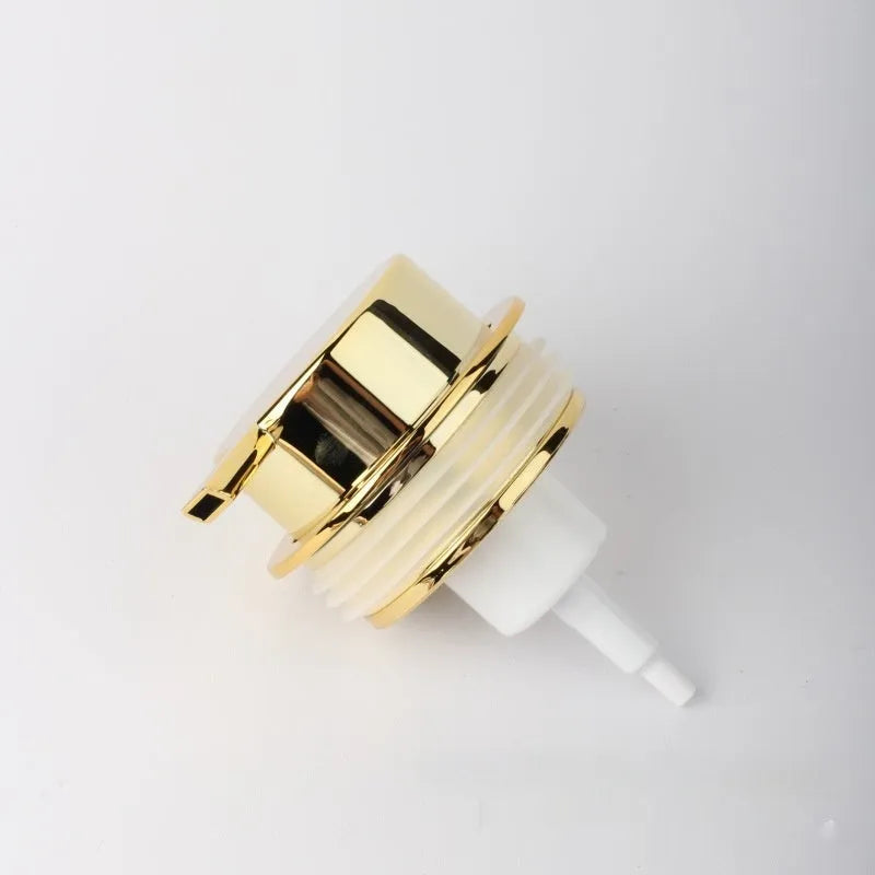 Large foam pump head for facial cleansers in metallic gold finish