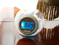 White colourful natural sound alarm clock with LCD display showing time and date