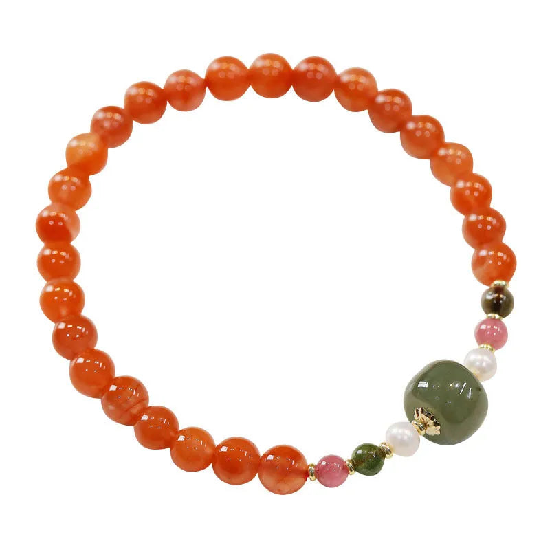 Close-up of a women's bracelet with round cherry red South Red Agate beads in a retro ethnic style.