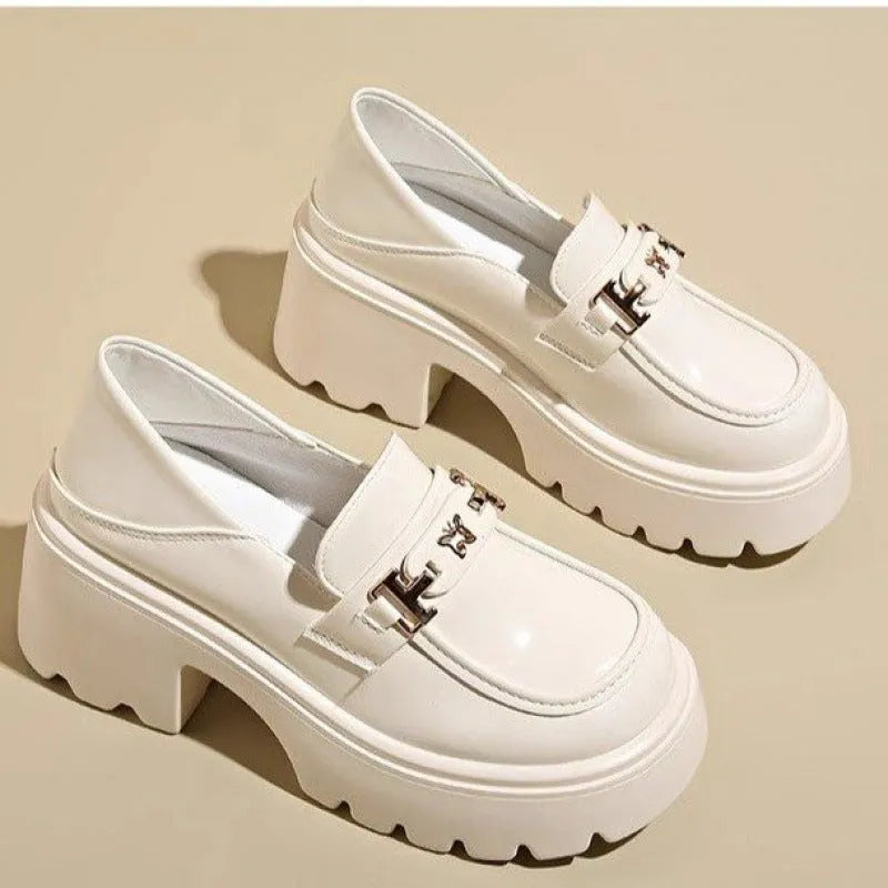Black women's slip-on shoes with a skull pattern, chunky square heel, and round toe on a white background.