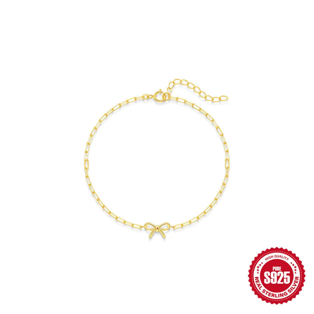 Gold plated sterling silver bracelet with geometric heart charm and clip chain clasp