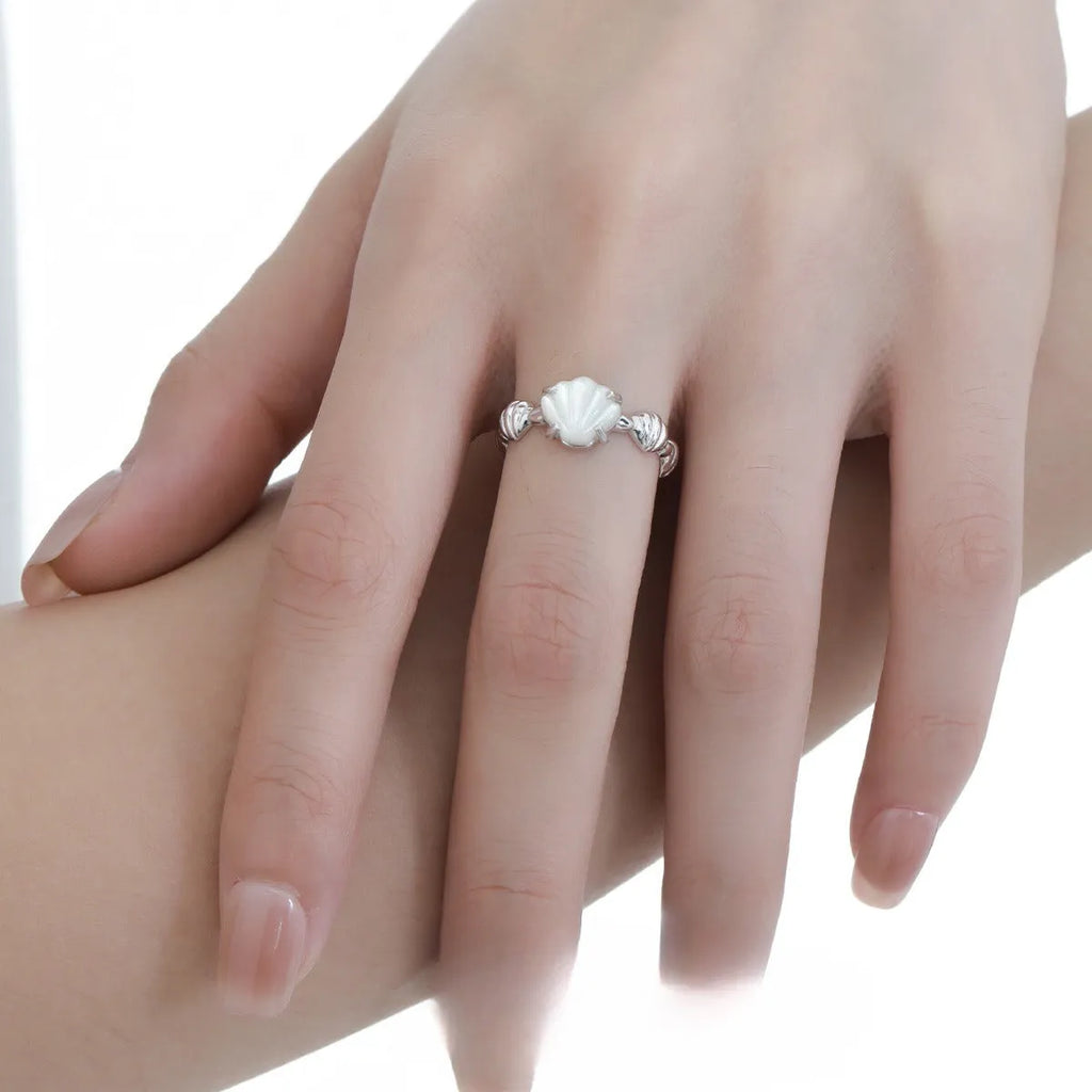 Adjustable silver ring with a shell design and tiger eye stone in white gold or gold finish.