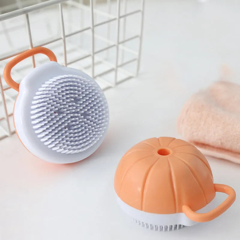 Orange dog bath brush with shampoo dispenser and soft TPR bristles on a curved pumpkin-shaped handle.