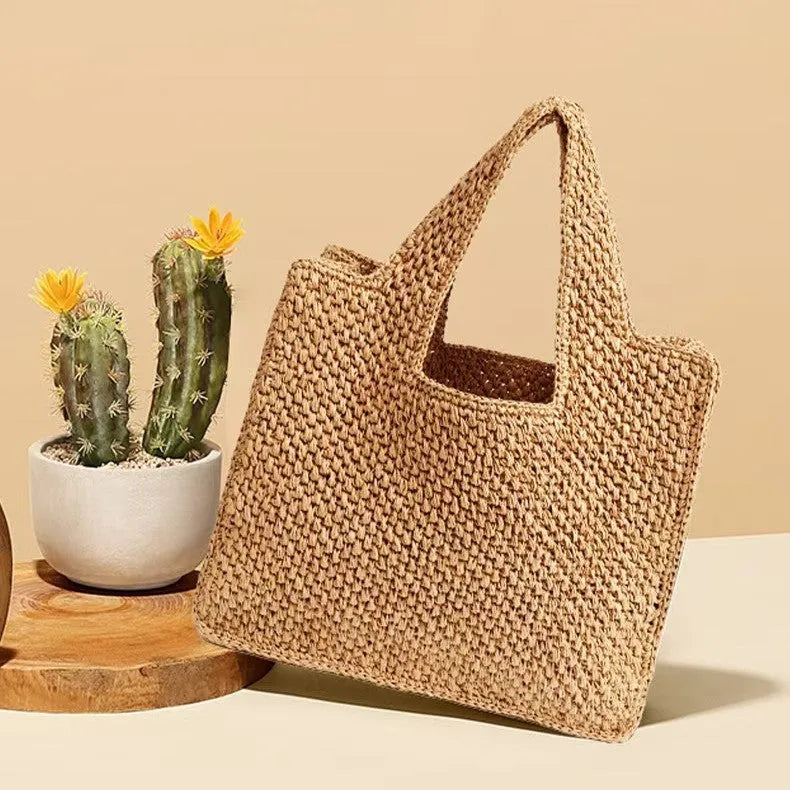 Horizontal square woven straw tote bag with open pockets and double shoulder straps