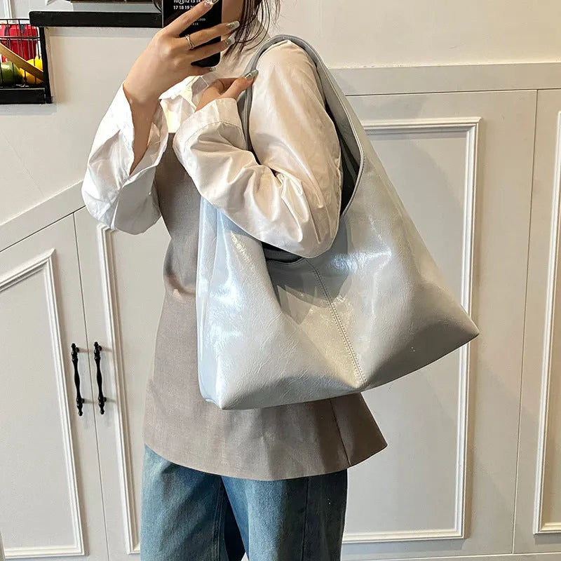 One shoulder tote bag in cream yellow with square vertical shape, outer slit pocket, internal phone bag, PU outer and polyester lining