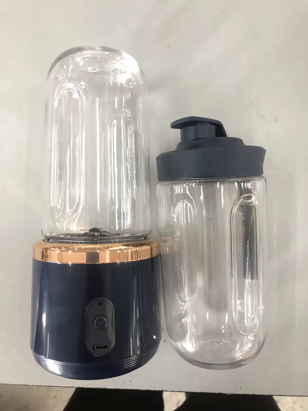 Portable USB blender and juicer in Tunisian dark blue with six blades, a cup lid, and a USB cable.