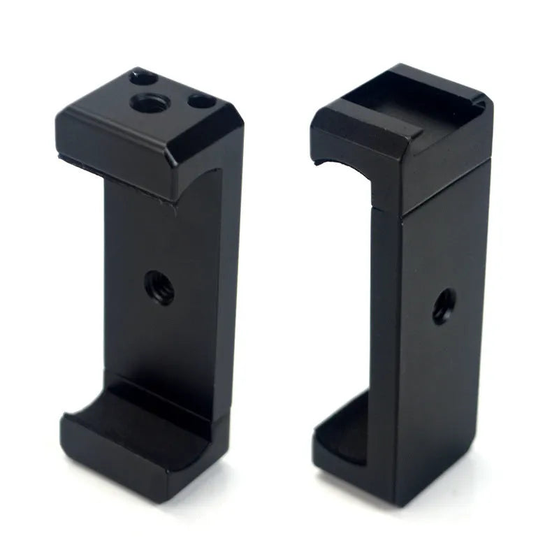 Silver aluminium smartphone bracket for tripod mounting next to a mobile phone.
