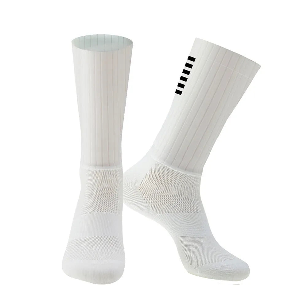 A pair of breathable cycling and running socks in an orange colour on a plain background.