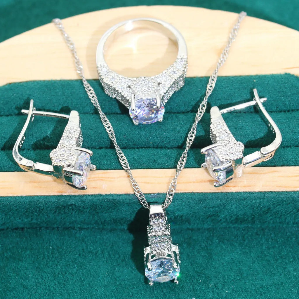 Zircon bridal jewellery four-piece set showing necklace, earrings, bracelet, and ring with alloy pendant