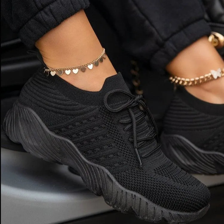 Women's solid colour sneakers with a thick sole, shown in one of nine available colours.