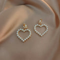 Heart shaped ear clip earrings for women with imitation pearl heart detail and retro round face, 1 pair