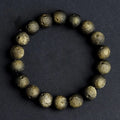 Natural obsidian crater ball bracelet with textured beads in silver stone meteorite finish.