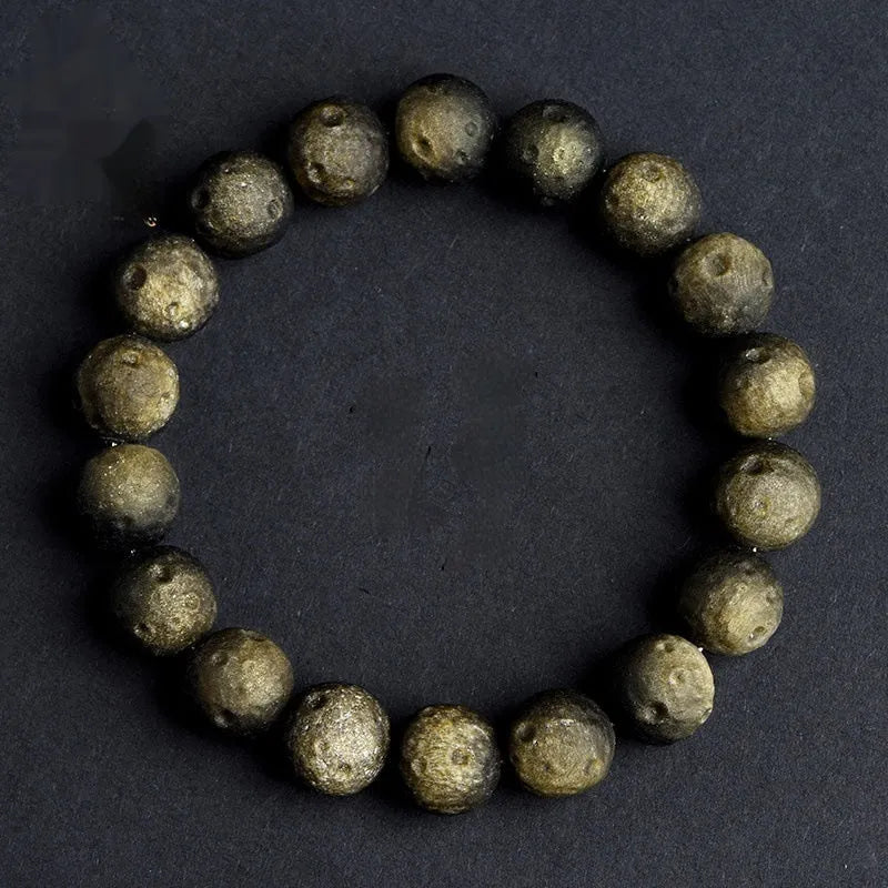 Natural obsidian crater ball bracelet with textured beads in silver stone meteorite finish.