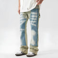 Retro yellow and blue patchwork jeans with splash-ink and damaged design details.