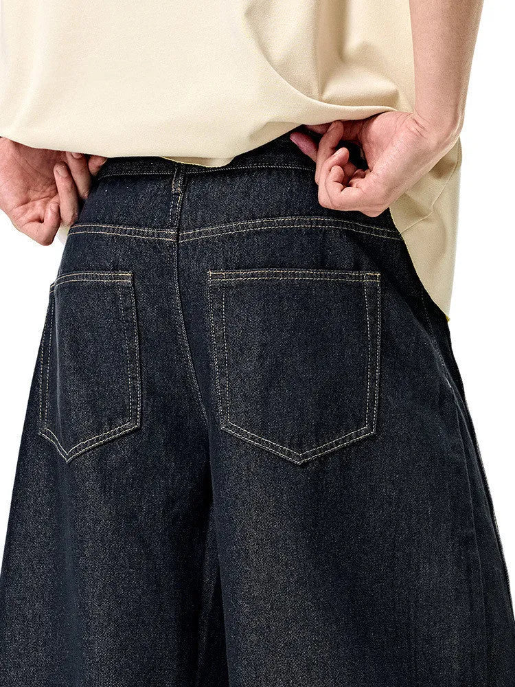 Men's wide leg denim trousers in original cow colour, showing mid-waist and relaxed fit.