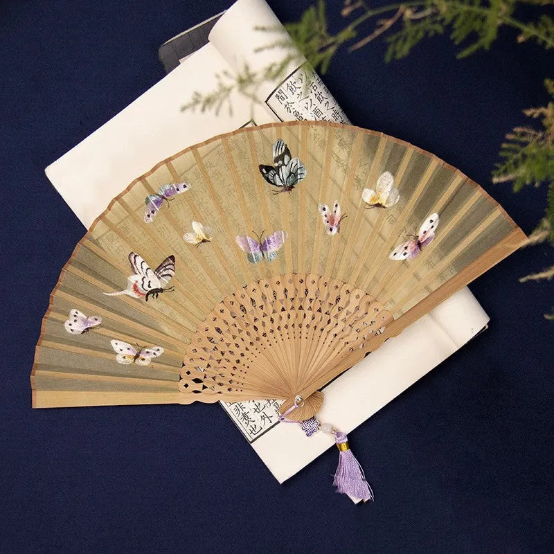 7-inch bamboo folding silk embroidered fan showing traditional Chinese embroidery designs