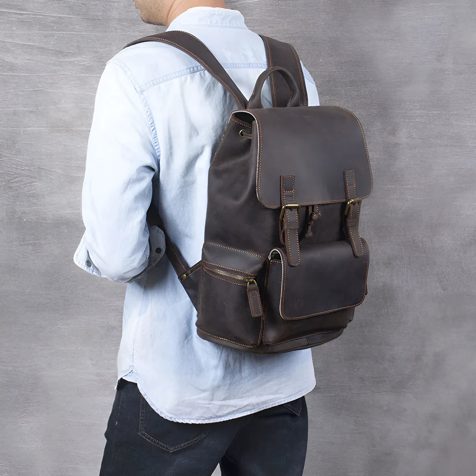 Brown genuine cowhide leather backpack with double shoulder straps and a soft handle.