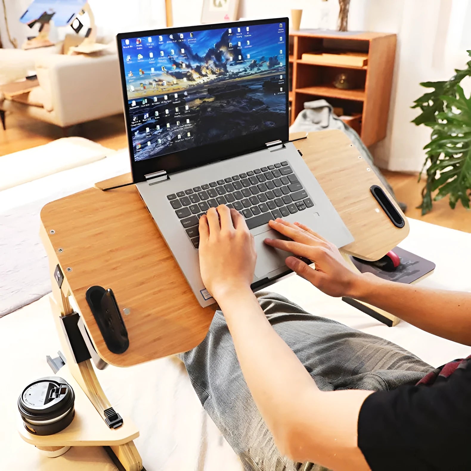 White maple folding wooden desk with adjustable angle, shown open on a bed with a laptop.