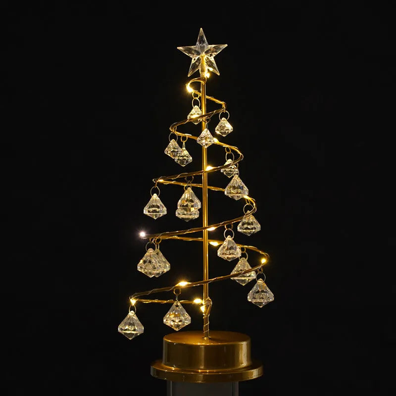 Gold crystal Christmas tree LED light with battery-powered warm glow on a shelf