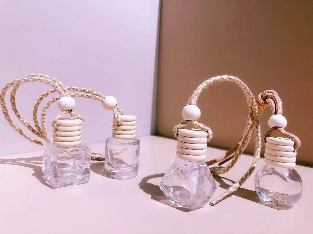 Car perfume pendant in glass bottle showing cylinder, diamond, flat drum and square style options