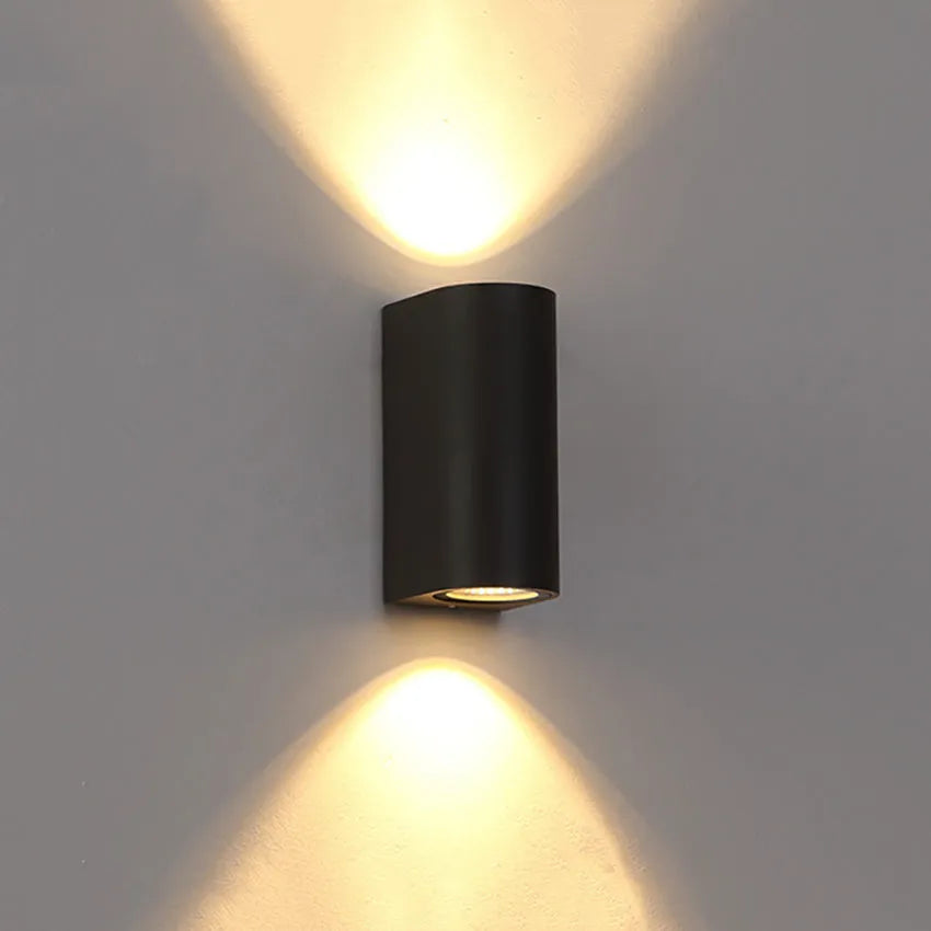 Modern black wall lamp with aluminium body, glass shade, and integrated LED light source.