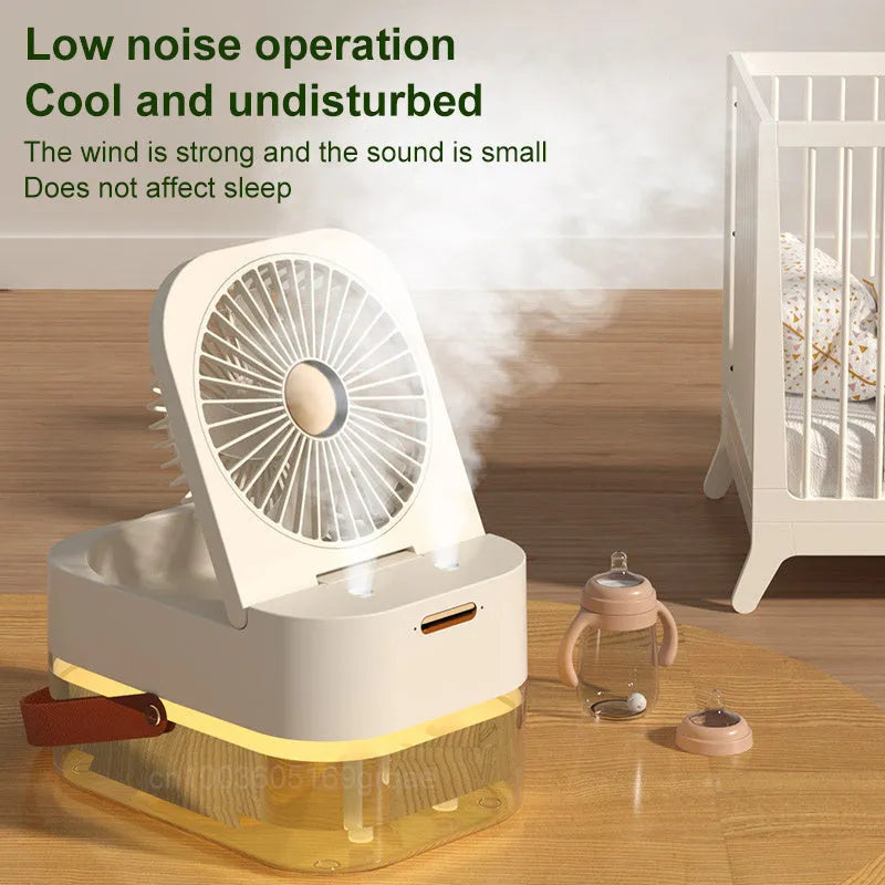 Pearl white USB desktop humidifier mist fan with water tank, remote control, and night light on a wooden desk.
