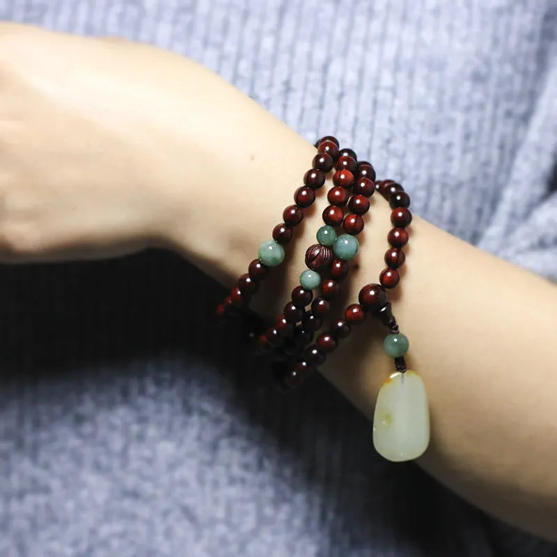 Carved rosewood bead bracelet with a Hotian Jade pendant, showing 6mm and 8mm size options.