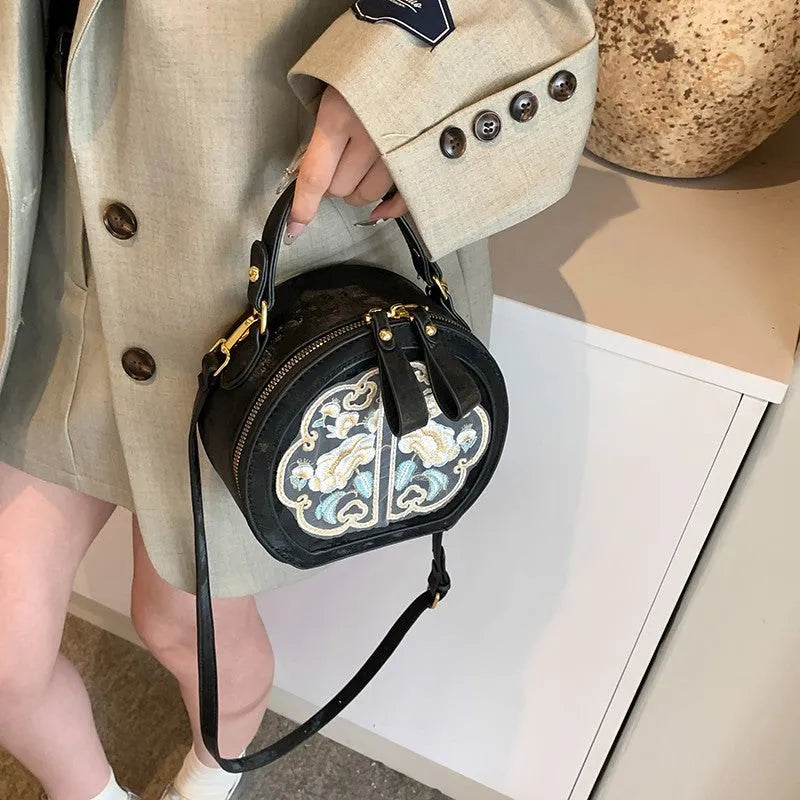Soft PU Chinese embroidery messenger bag in horizontal square shape with adjustable shoulder strap.