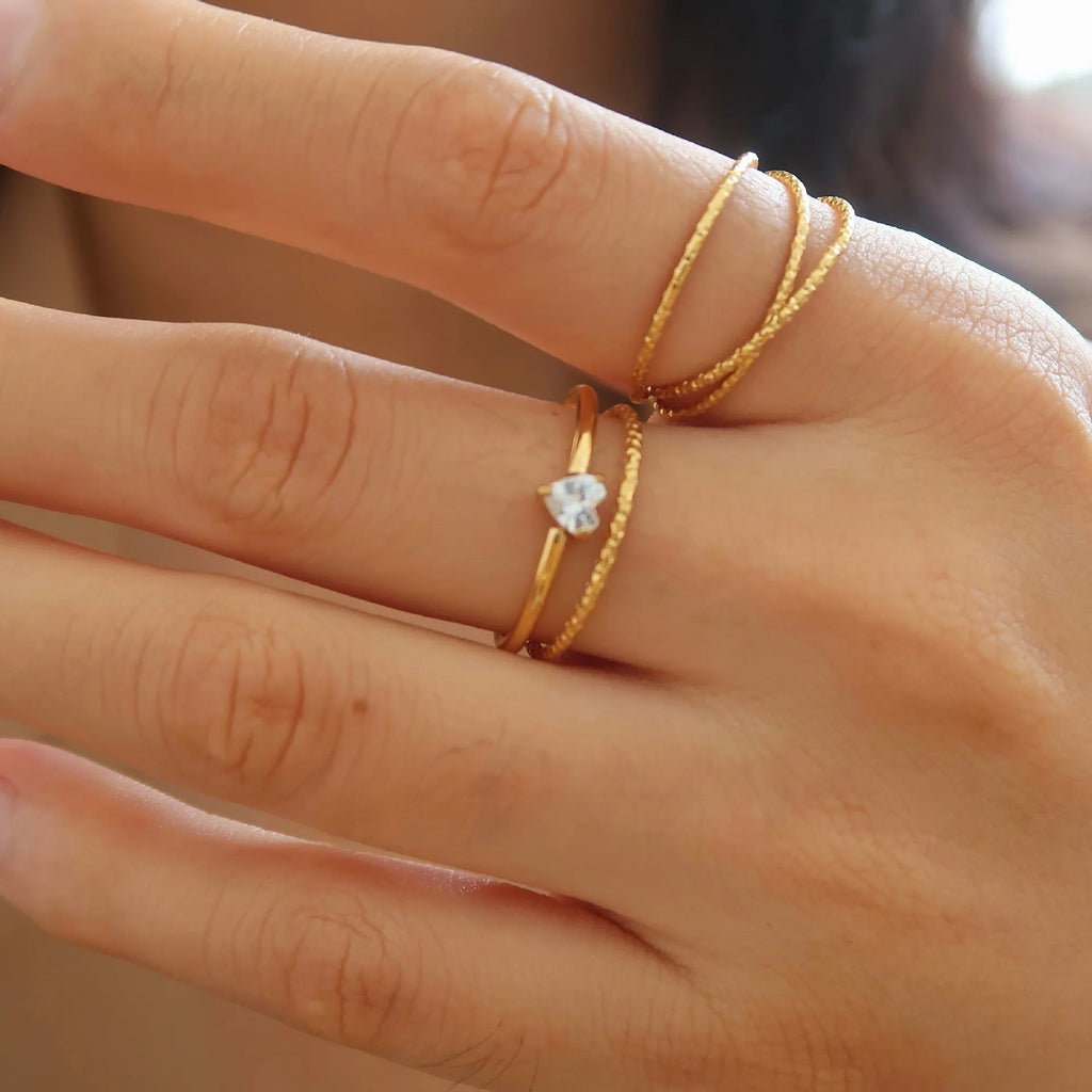 Golden heart-shaped stainless steel ring with electroplated finish available in two colour variations
