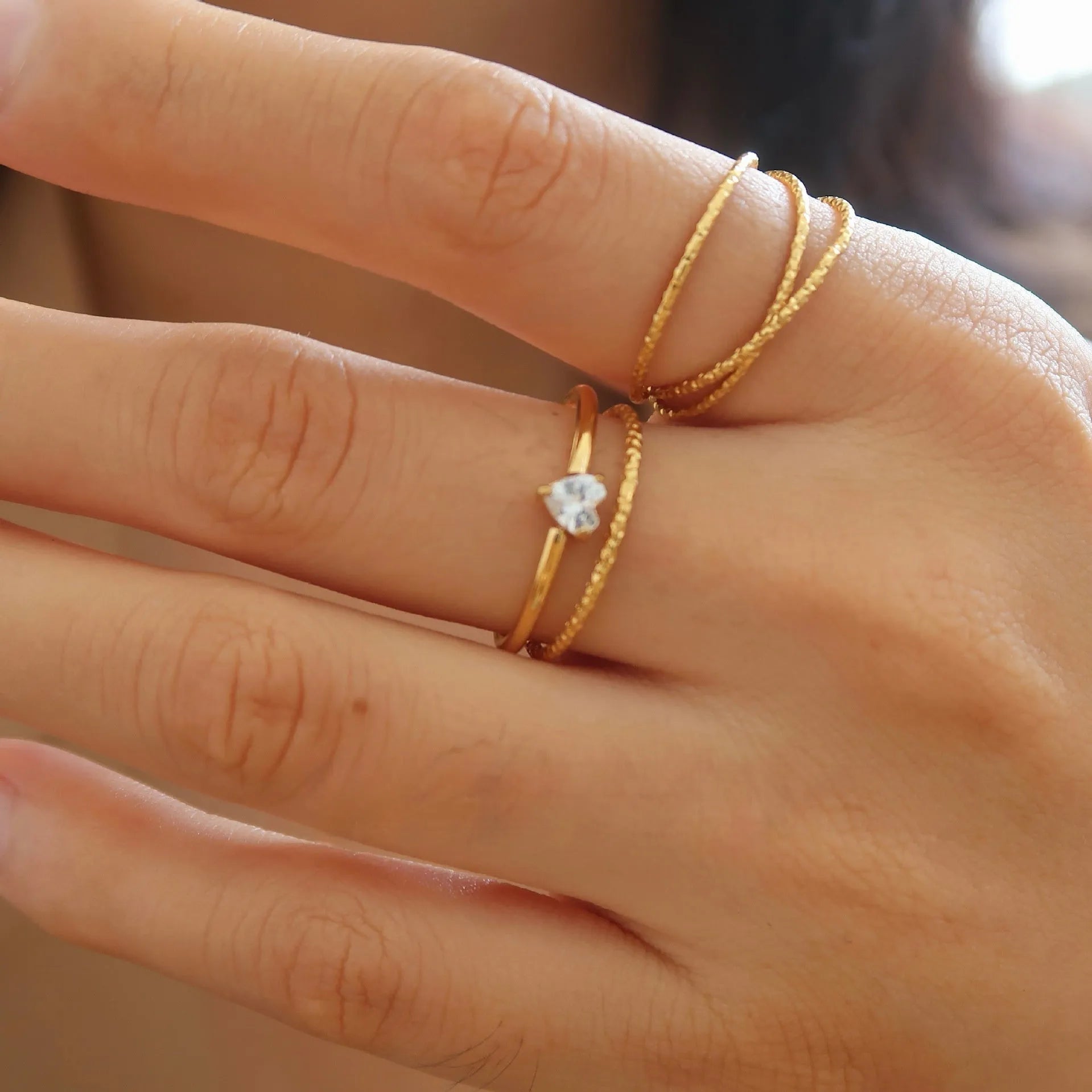 Golden heart-shaped stainless steel ring with electroplated finish available in two colour variations
