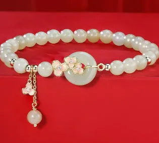 Peach blossom Hetian jade bracelet and necklace set with floral beads in sterling silver mounting