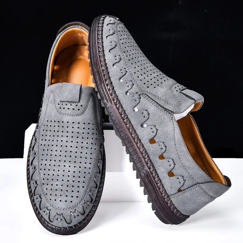 Men's brown slip-on casual shoes with a round toe and flat heel, showing hollowed-out design details.