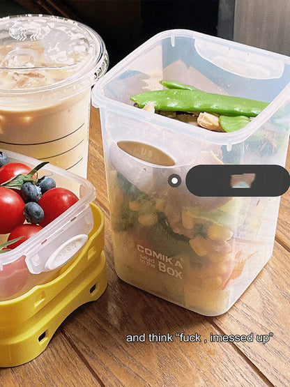 A portable bento box with two compartments for storing different types of food, such as salad, yogurt, oatmeal, and milkshake.