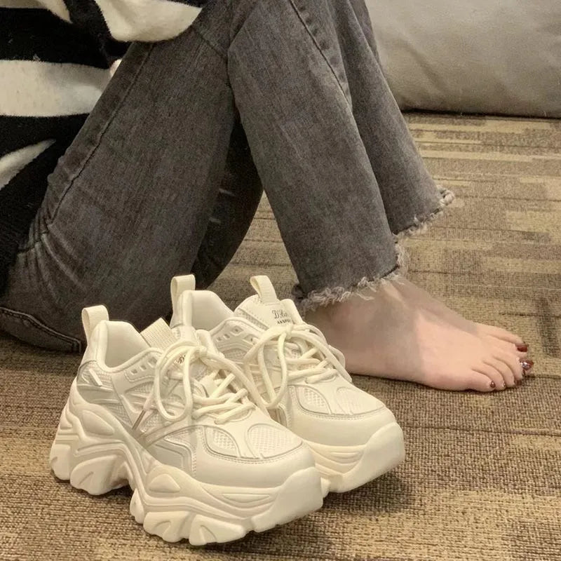 Mid-top platform trainers with 6-8cm high heel, cross strap synthetic leather upper, Goodyear rubber sole, black or creamy white