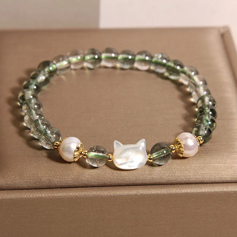 Green phantom quartz women's bracelet with a delicate shell kitten charm.