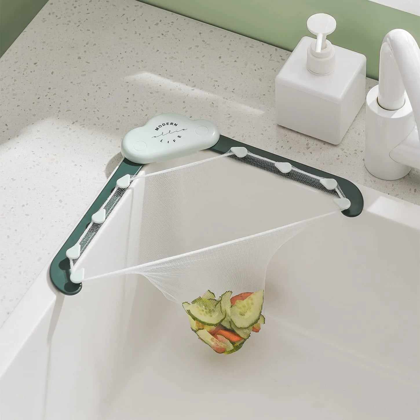 Green triangular ABS plastic sink drain rack with elastic mesh filter net installed in kitchen sink corner.