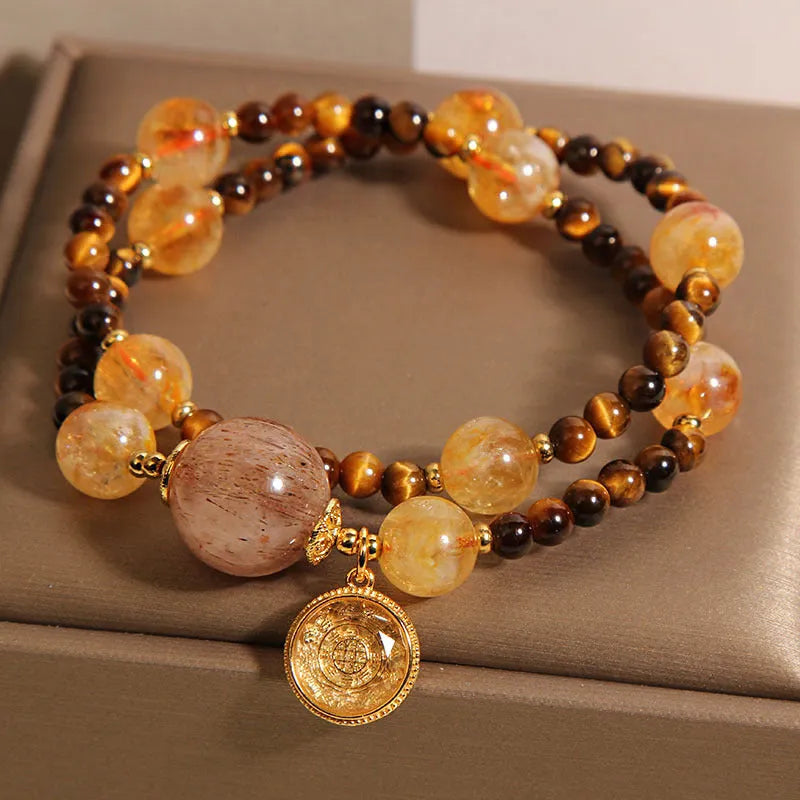 Double circle natural citrine tiger-eye bracelet with yellow tower crystal on white background
