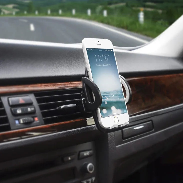Black plastic universal car phone holder mounted on a car air vent