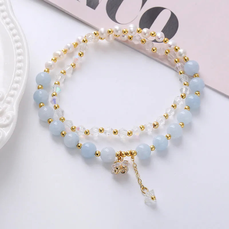 Women's double ring bracelet with freshwater pearls and coloured crystals in amethyst, aquamarine, or strawberry quartz options