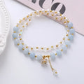 Women's double ring bracelet with freshwater pearls and coloured crystals in amethyst, aquamarine, or strawberry quartz options