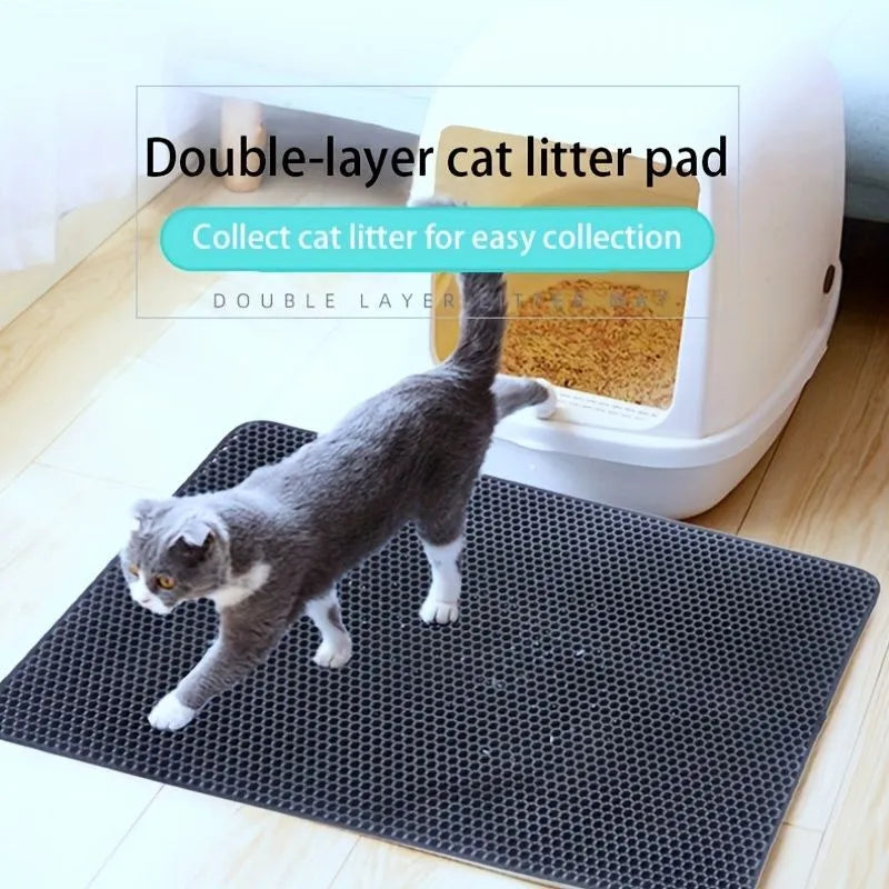 Black waterproof EVA cat litter mat with honeycomb texture and quilted edge on a wooden floor