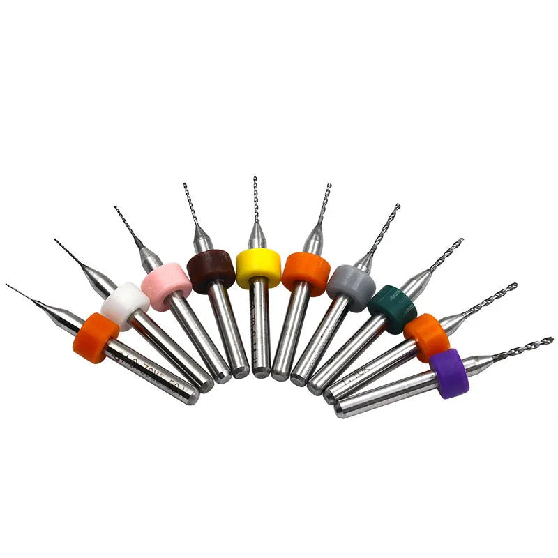 Ten small tungsten carbide circuit board drill bits with straight 3.2mm shanks on a white background.