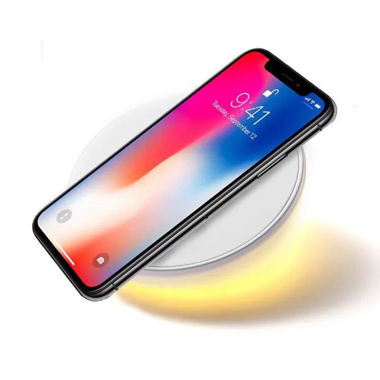 White wireless charger with clock display and three control buttons for mobile phone charging