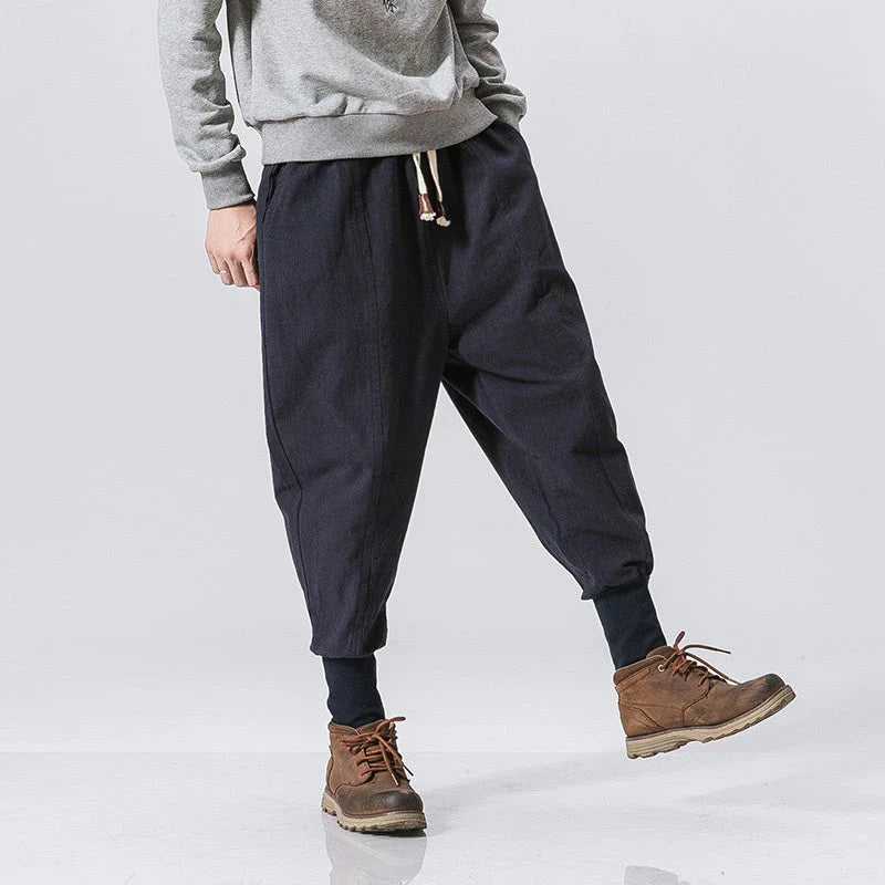 Comfortable linen and cotton harem pants for men, featuring an elastic waistband and a relaxed, trendy silhouette