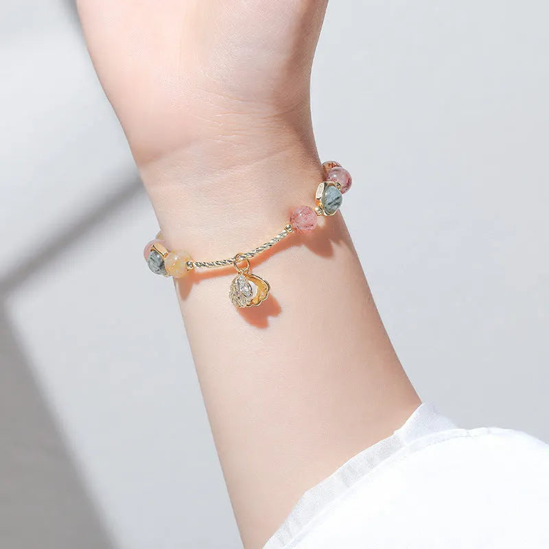 Colourful crystal shell bracelet with red sealant flower designs and animal zodiac motifs