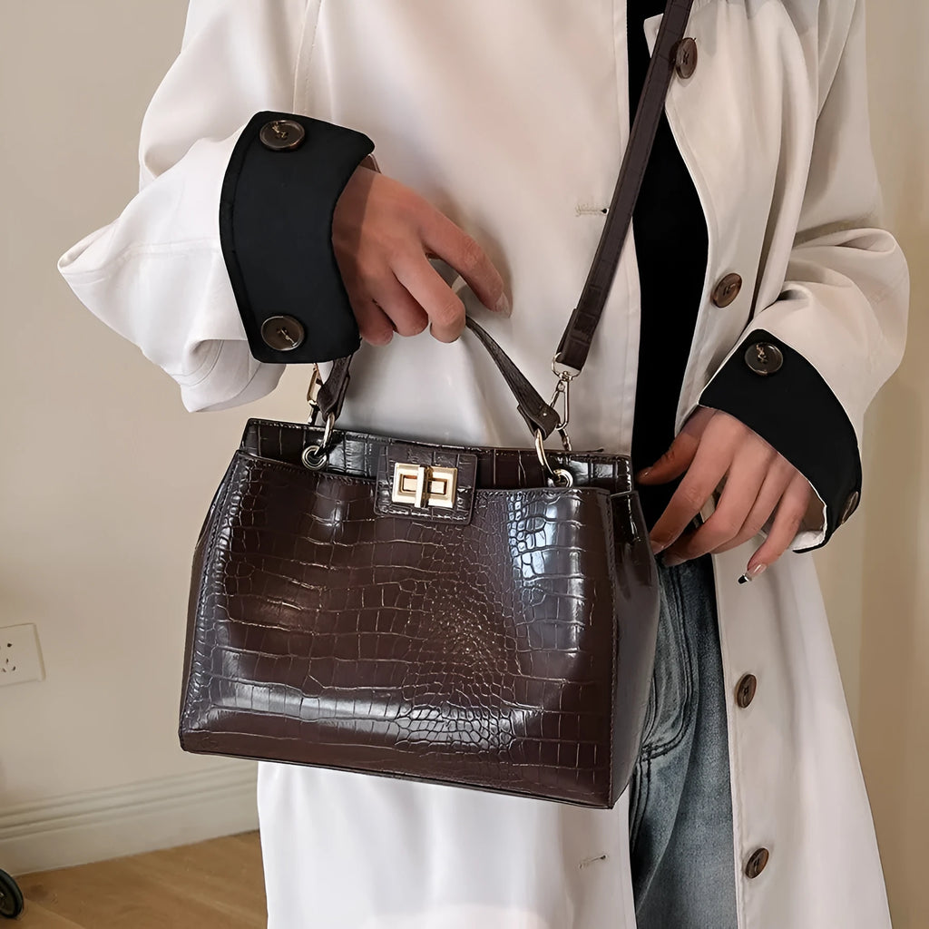Retro western style messenger bag in black stone pattern with shoulder strap and square vertical shape