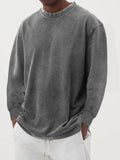 Man wearing a slim fit long sleeve t-shirt in a solid colour, with options in sky blue, green, gray, black, and camel.