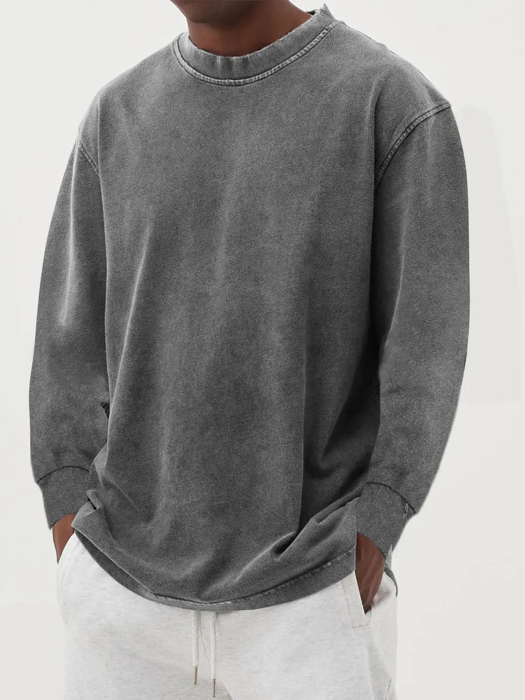 Man wearing a slim fit long sleeve t-shirt in a solid colour, with options in sky blue, green, gray, black, and camel.