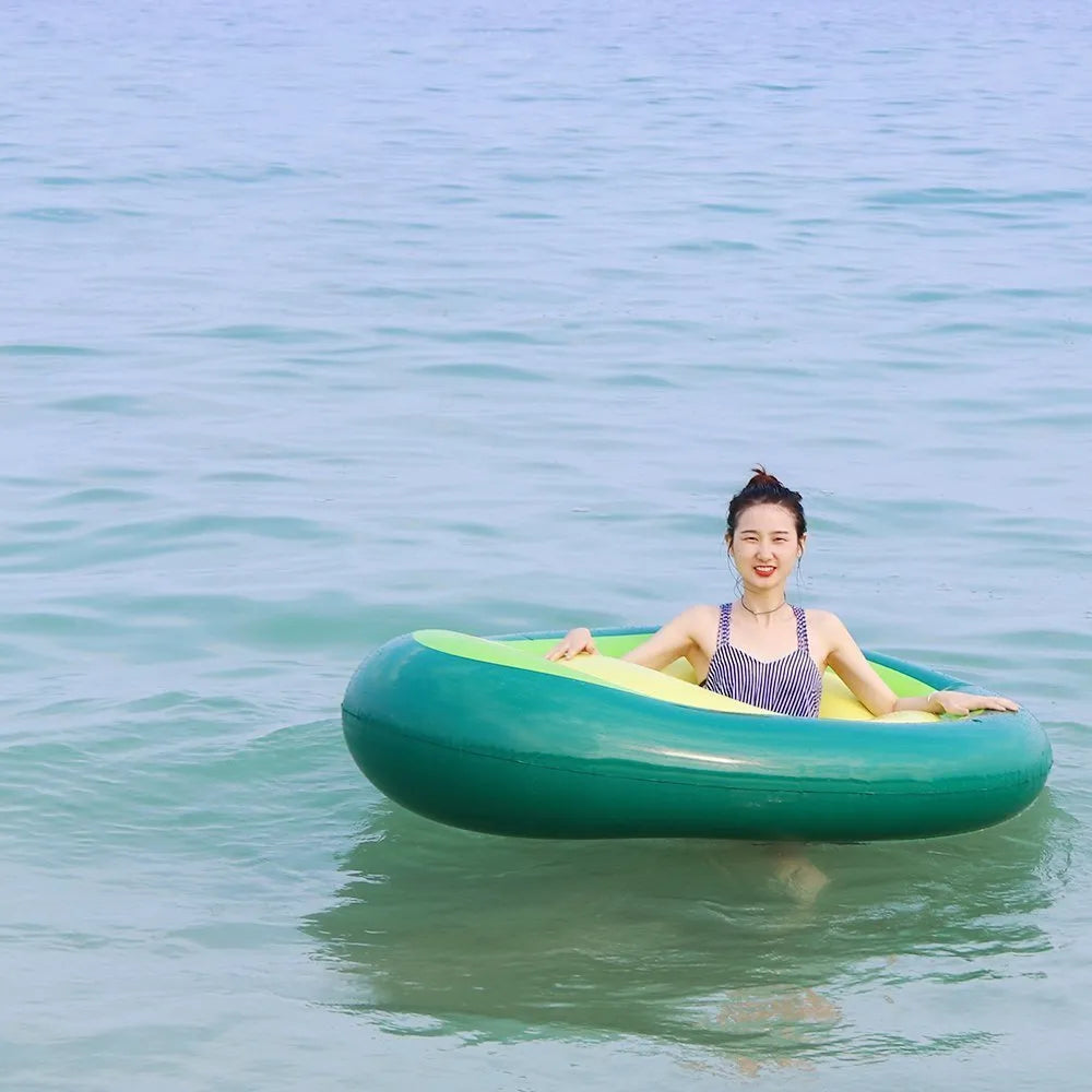 Green avocado-shaped inflatable pool float with dimensions 169cm by 130cm.