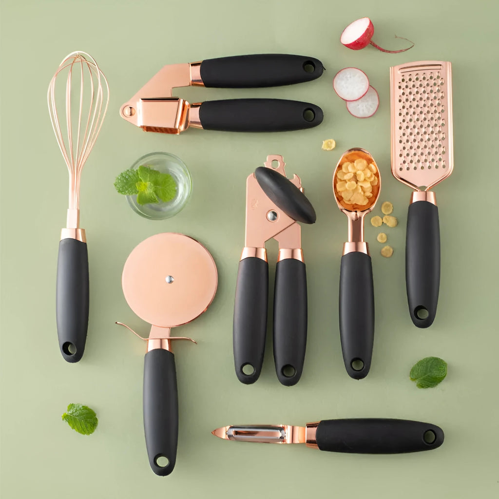 Seven-piece stainless steel kitchen tool set with copper plating on a matching storage rack.